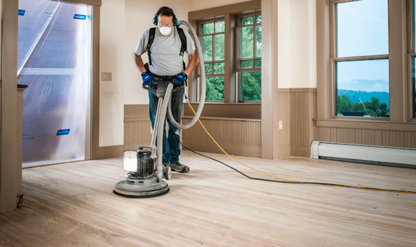 During deep cleaning hardwood floors, it is important to abrade the floors with a polishing pad while vacuuming to extract the dust.